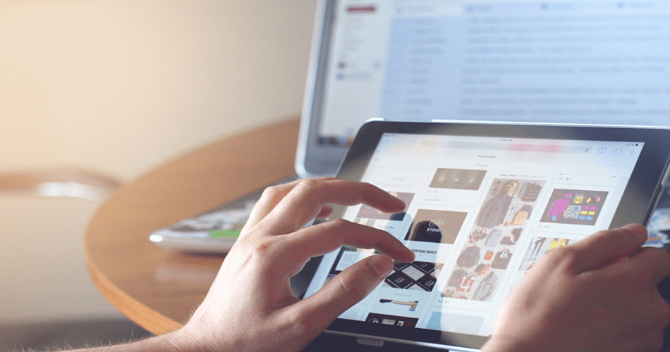 A person using an iPad to browse online news, symbolizing access to media coverage and digital storytelling featured on our Press page.